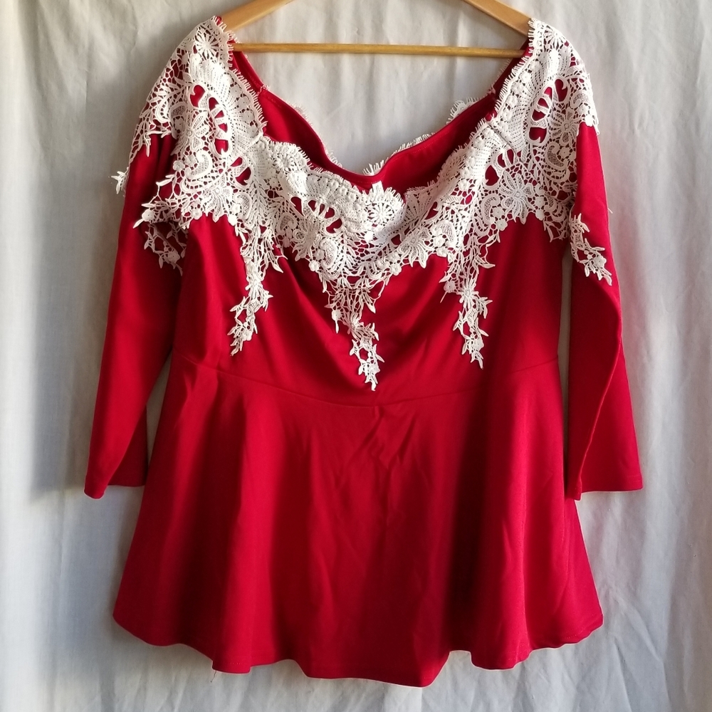 Red blouse with lace motif.